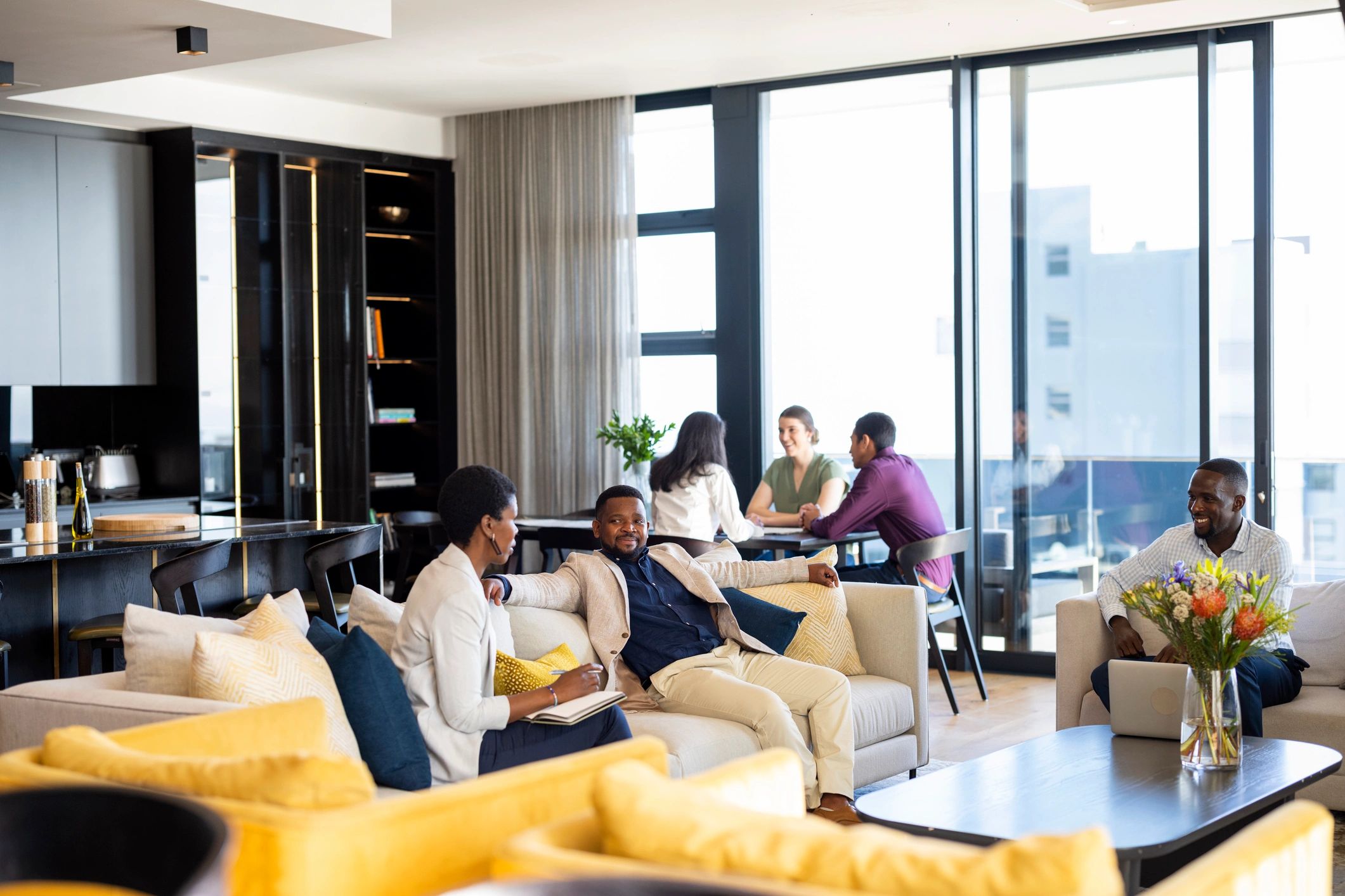 Real estate professionals meeting with clients in a modern office